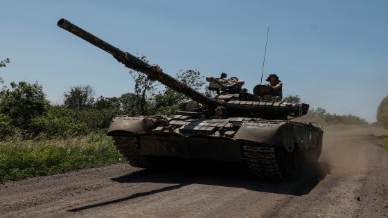 Ukrainian servicemen of the 30th Kostiantyn Ostrozkyi Separate Mechanized Brigade ride in a T-80 main battle tank captured earlier from Russian troops, along a road near the front line town of Bakhmut, amid Russia's attack on Ukraine, in Donetsk region, Ukraine June 19, 2023. Radio Free Europe/Radio Liberty/Serhii Nuzhnenko via REUTERS