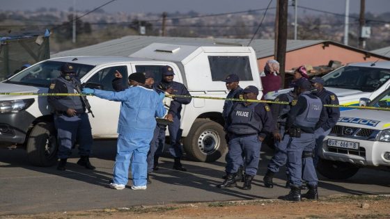Members of the South African Police Service (SAPS) and forensic pathology service inspect the scene of a mass shooting in Soweto, South Africa, on July 10, 2022. - Fourteen people were killed during a shootout in a bar in Soweto police said on July 10, 2022.
Police lieutenant Elias Mawela said that they were called in the early hours in the morning, around 12:30am after the shooting overnight Saturday and Sunday.
When police arrived at the scene, 12 people were confirmed dead.
11 others were taken to hospital with wounds but two later died, raising the death toll to 14. (Photo by Ihsaan HAFFEJEE / AFP)