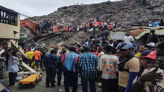 Residents and rescuers use an excavator to search for bodies after a landslide struck the Dar es Salaam dumpsite overnight in Conakry on August 23, 2026. Thirty people died and six were seriously wounded Sunday on the outskirts of Conakry, Guinea's capital, after a mound of rubbish in a landfill collapsed onto homes following heavy rains, said a government statement.
The accident happened at 2:00 am (0200 GMT) Sunday morning, at the Dar-es-salam neighbourhood in the Bbessia district, said the government statement. (Photo by AFP via Getty Images)
